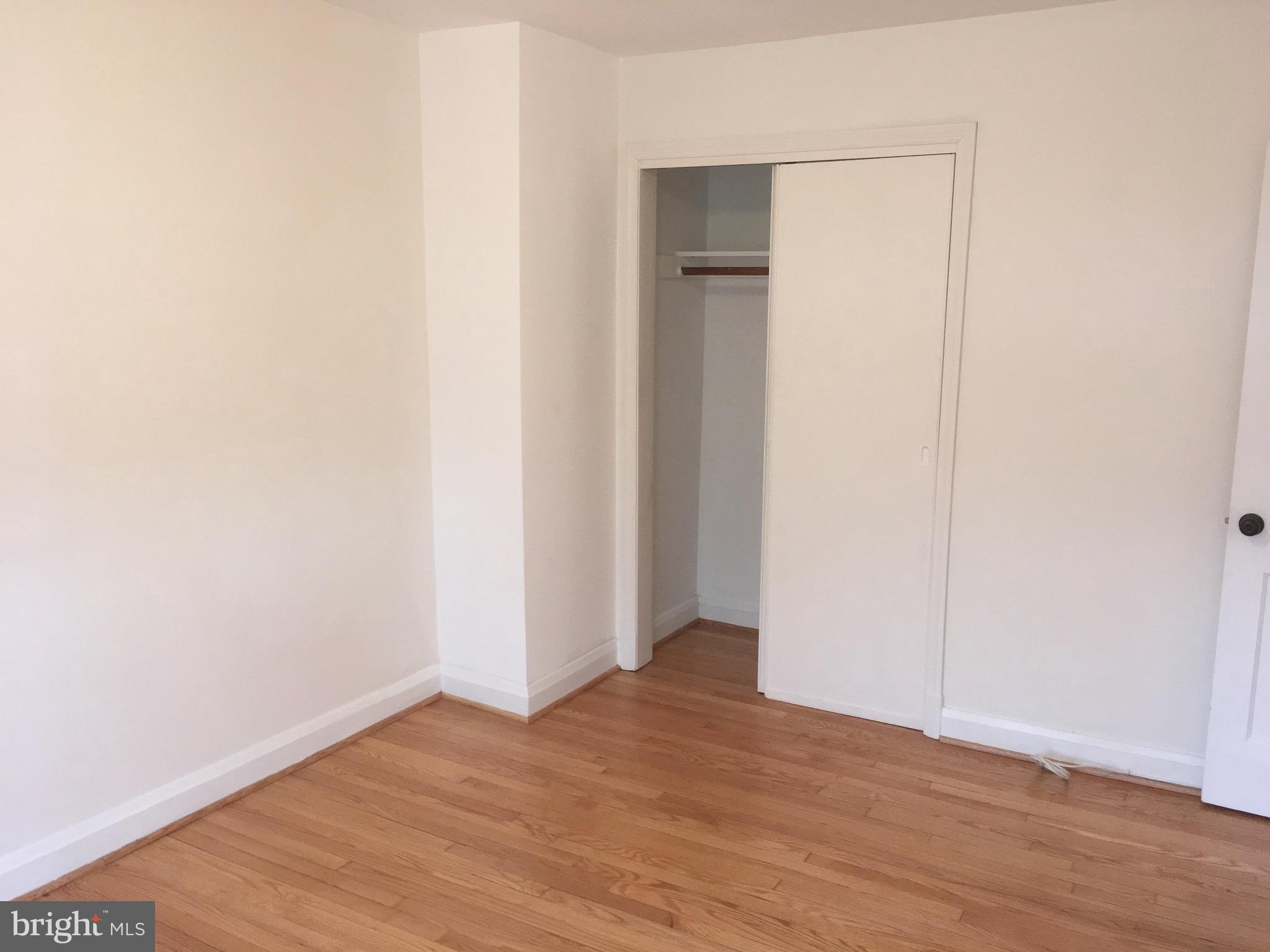 312 Stanmore Road Baltimore, MD 21212 - Photo 14 of 30 a view of an empty room with wooden floor and closet