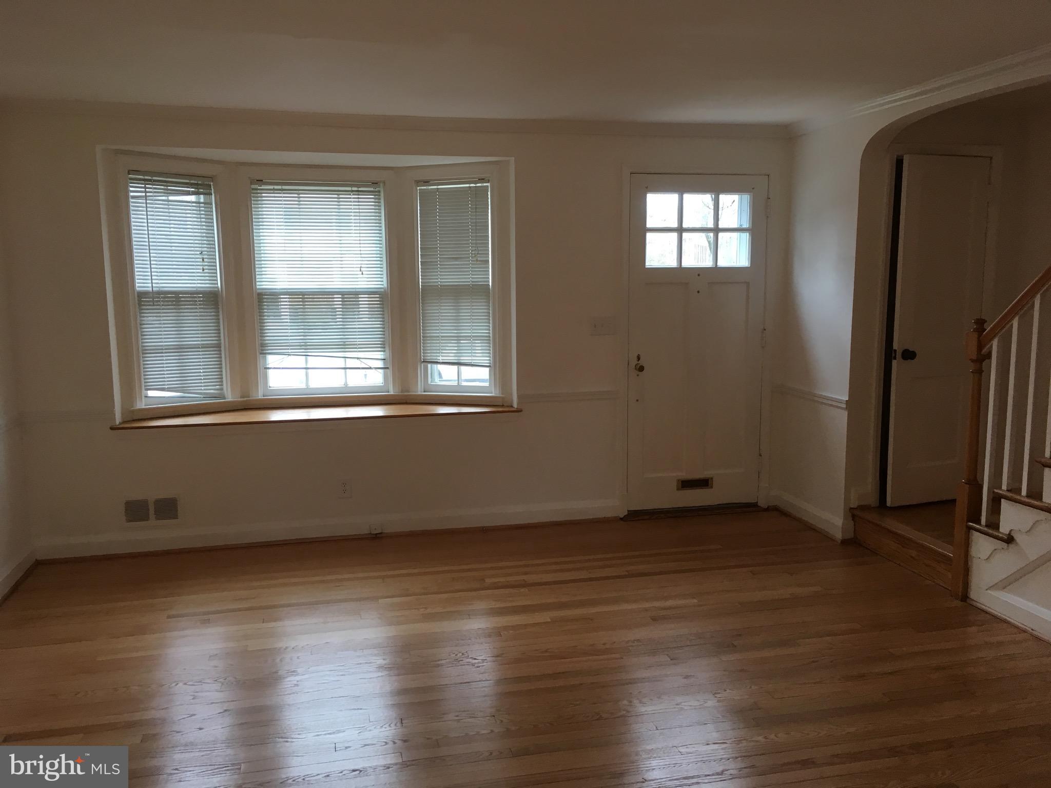 312 Stanmore Road Baltimore, MD 21212 - Photo 3 of 30 a view of an empty room with wooden floor and a window