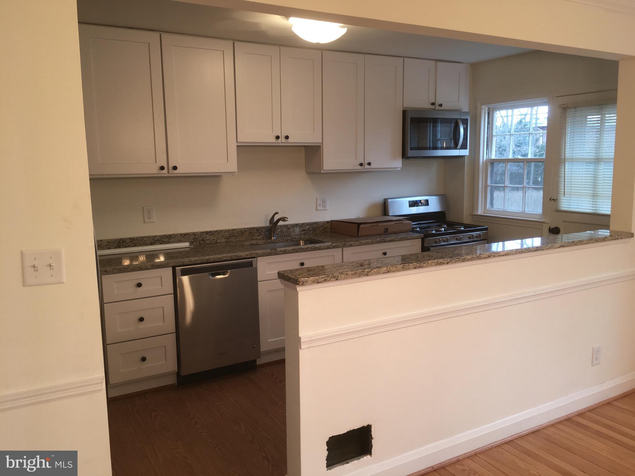 312 Stanmore Road Baltimore, MD 21212 - Photo 8 of 30 a kitchen with cabinets appliances a sink and a counter top space