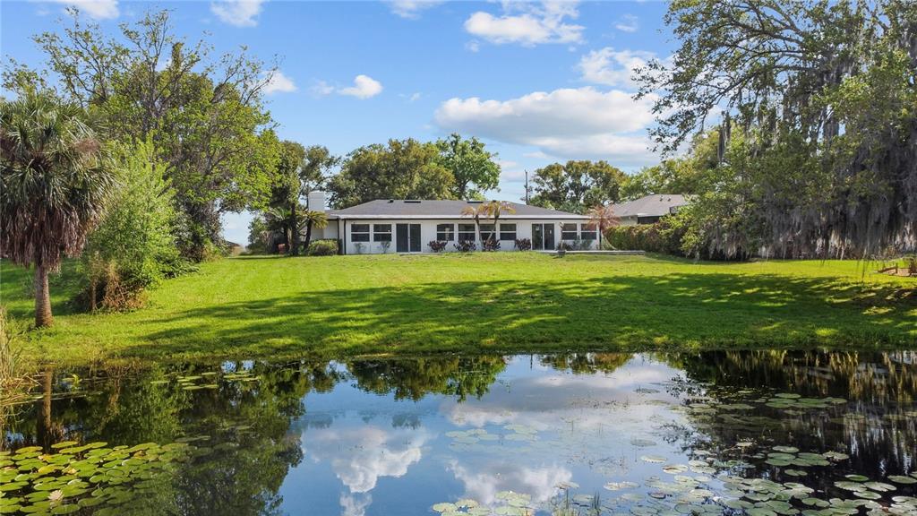 1501 Druid Isle Road Maitland, FL 32751 - Photo 2 of 54 a view of a big yard with large trees and plants