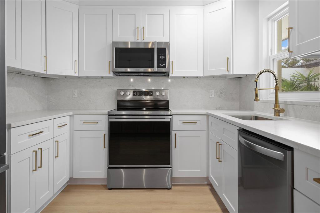 1501 Druid Isle Road Maitland, FL 32751 - Photo 21 of 54 a kitchen with cabinets stainless steel appliances and a sink