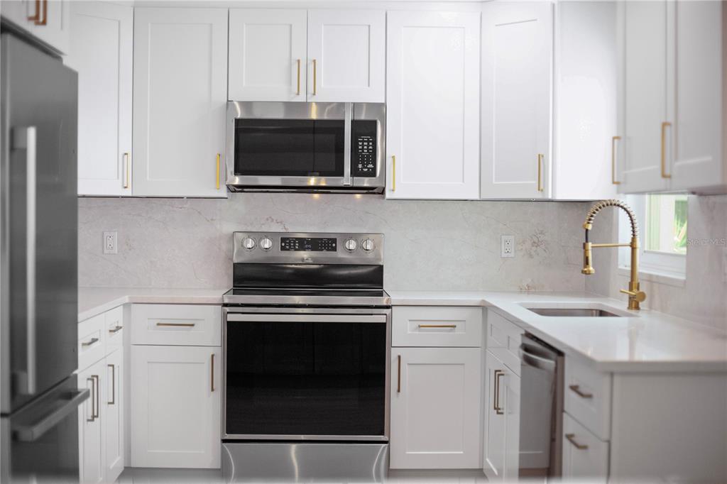 1501 Druid Isle Road Maitland, FL 32751 - Photo 23 of 54 a kitchen with white cabinets stainless steel appliances and sink