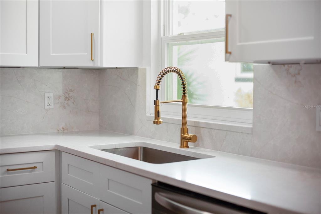 1501 Druid Isle Road Maitland, FL 32751 - Photo 24 of 54 a close view of a sink and dishwasher in kitchen with stainless steel appliances
