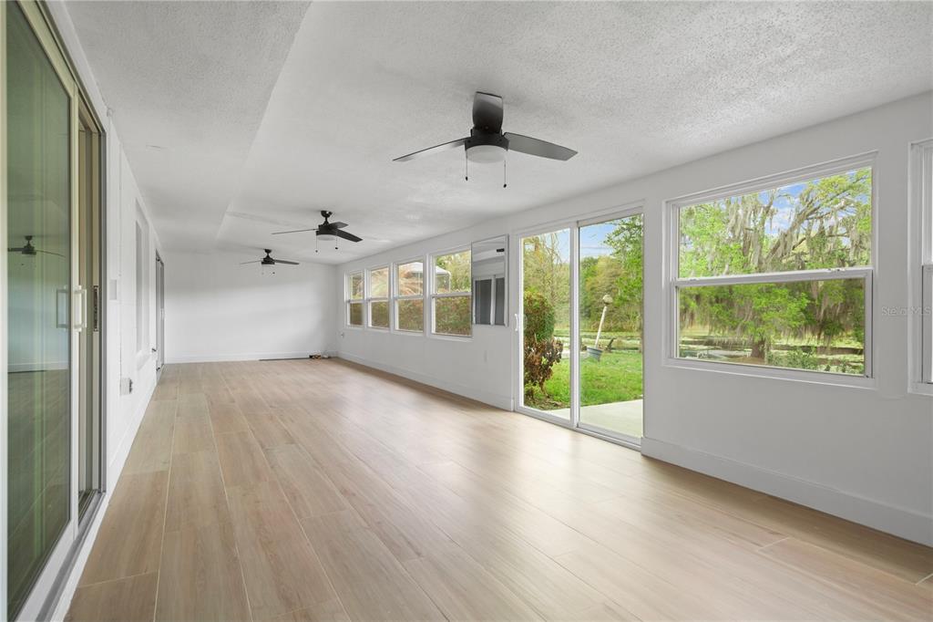 1501 Druid Isle Road Maitland, FL 32751 - Photo 30 of 54 an empty room with wooden floor and windows