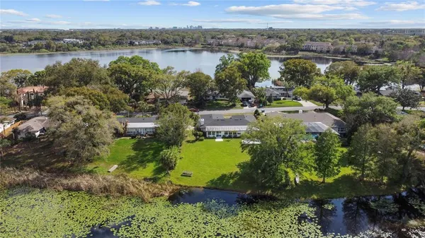 an aerial view of a houses with a lake