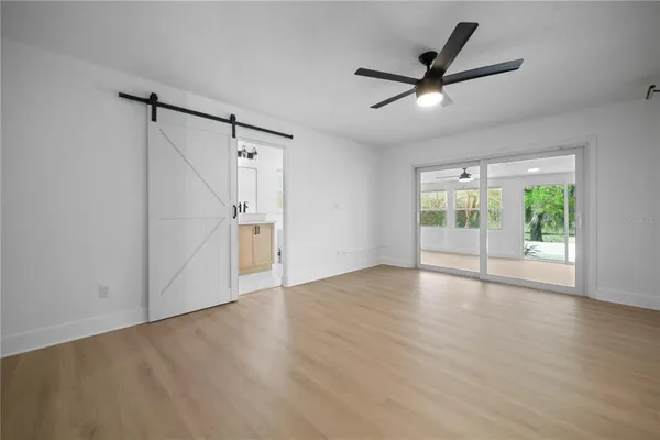a spacious bathroom with a double vanity sink a mirror and shower