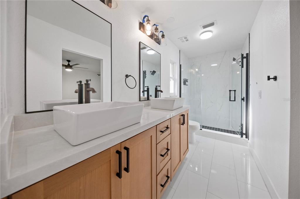 1501 Druid Isle Road Maitland, FL 32751 - Photo 37 of 54 a bathroom with a double vanity sink mirror and shower