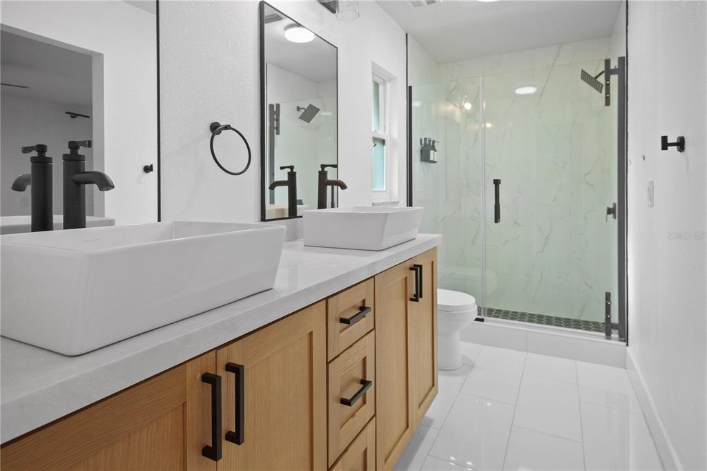 1501 Druid Isle Road Maitland, FL 32751 - Photo 38 of 54 a bathroom with a double vanity sink mirror and shower