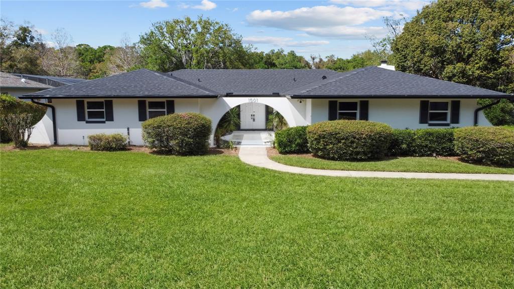 1501 Druid Isle Road Maitland, FL 32751 - Photo 7 of 54 a front view of a house with a yard and garage