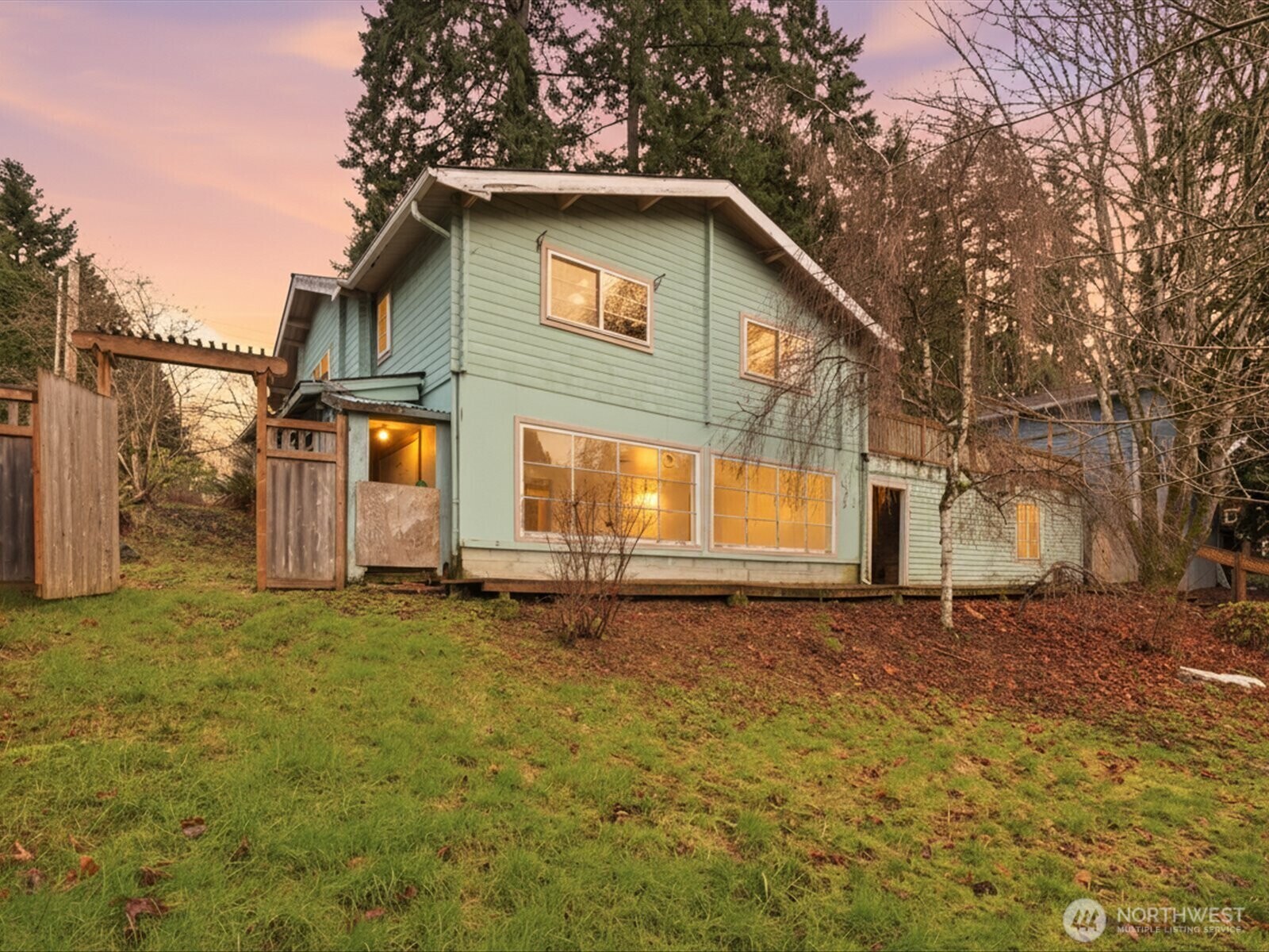 a white house that has a tree in front of it