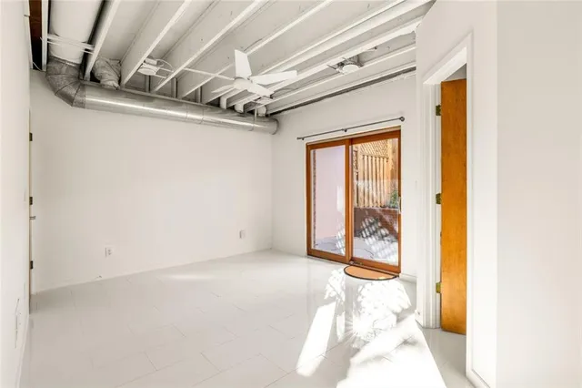 a view of small backyard with wooden fence