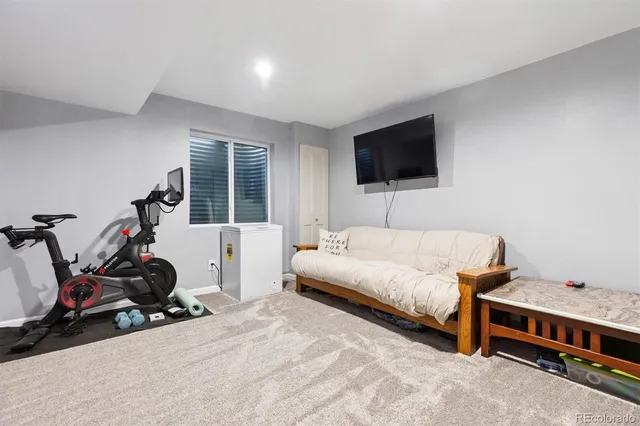 a bedroom with furniture and a flat screen tv