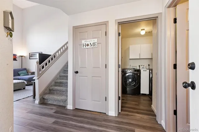 a view of a hallway with wooden floor and entryway