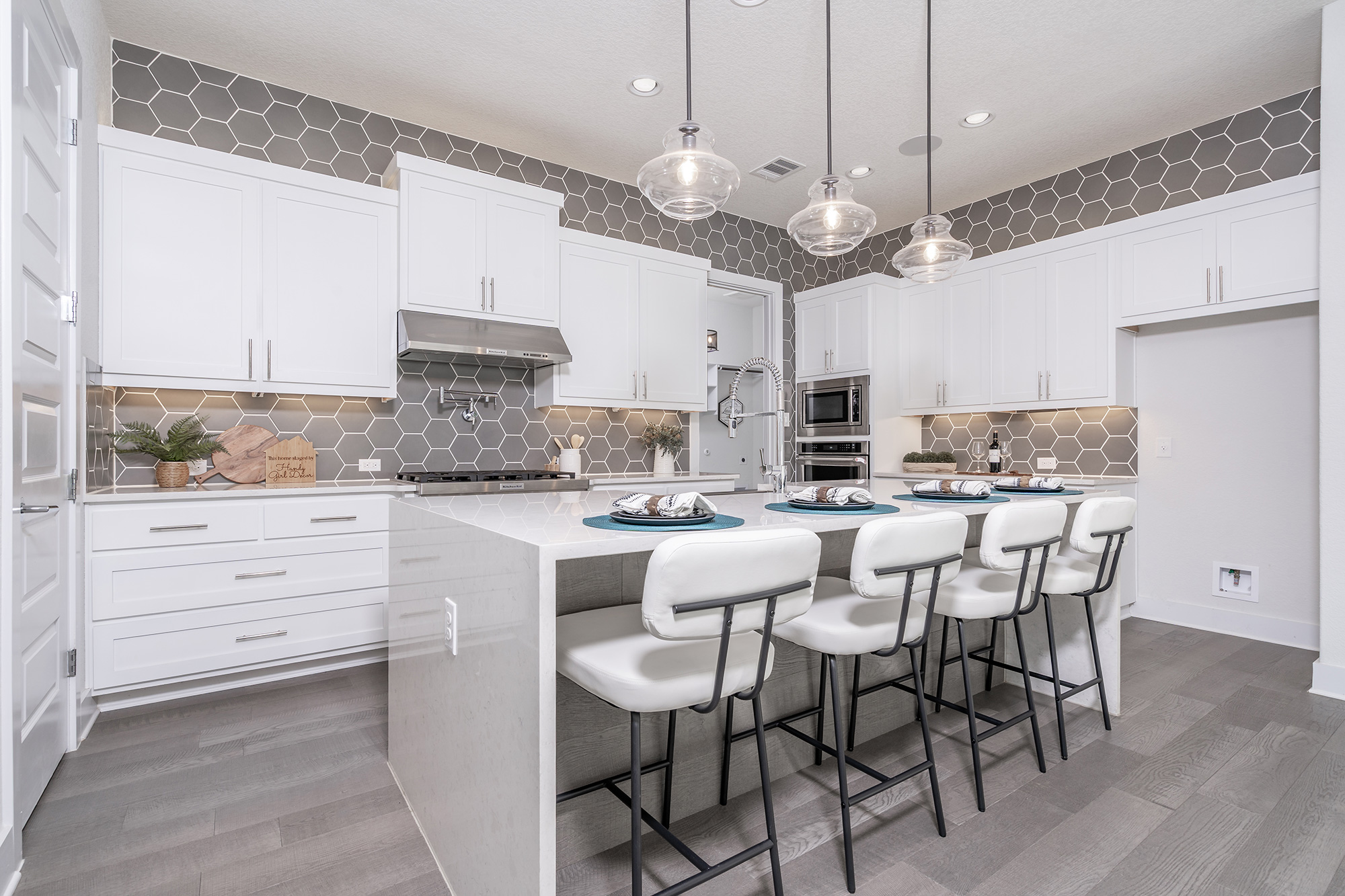 120 Diamondback Drive Georgetown, TX 78628 - Photo 14 of 39 a kitchen with stainless steel appliances kitchen island granite countertop a table chairs and a refrigerator