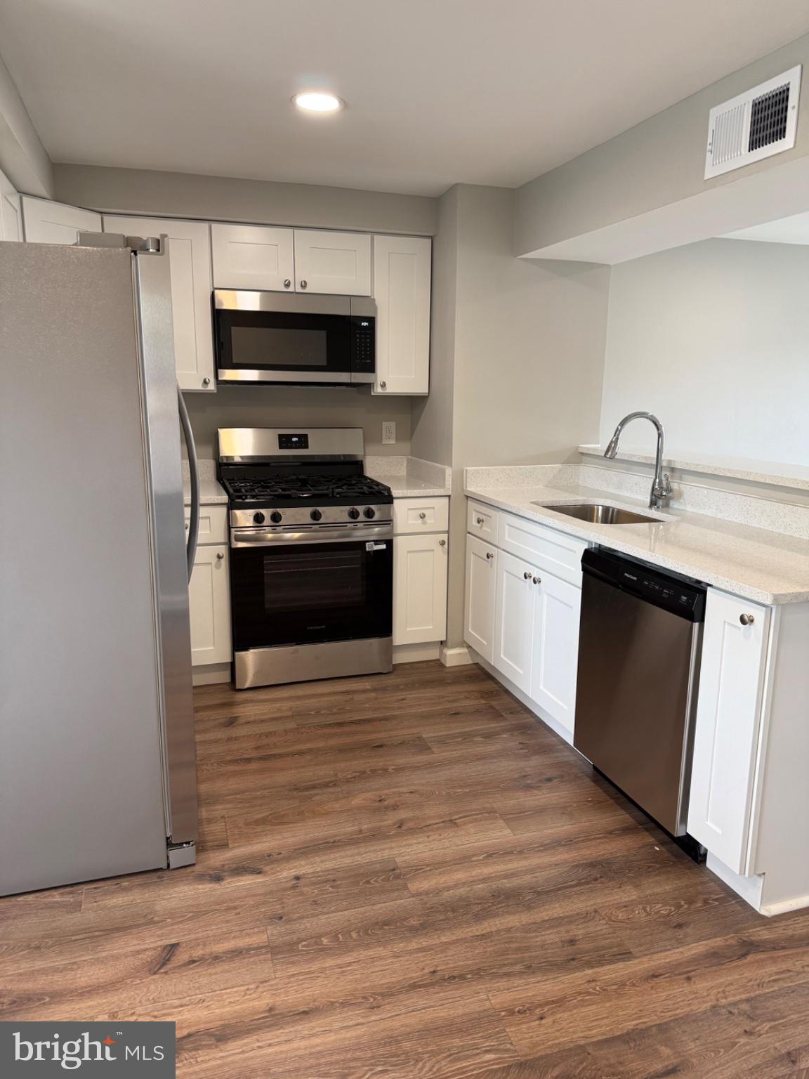 2908 Mallview Road Baltimore, MD 21230 - Photo 6 of 22 a kitchen with stainless steel appliances granite countertop a stove top oven a sink and a microwave