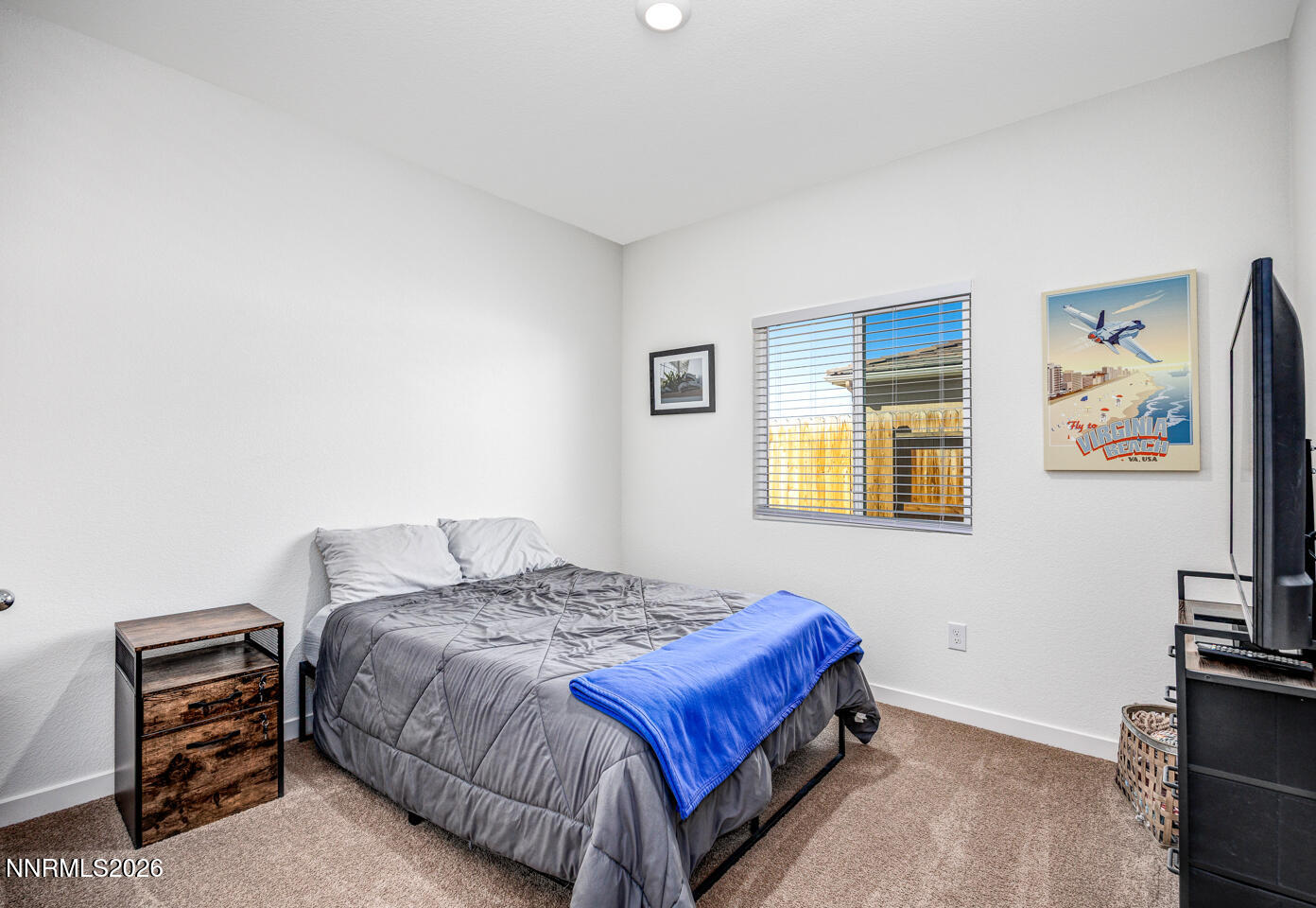 1049 Tamarack Court Fallon, NV 89406 - Photo 12 of 27 a bedroom with a bed and a dresser with a bookshelf