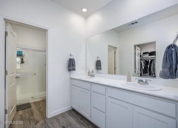 a view of walk in closet with clothes and shoes