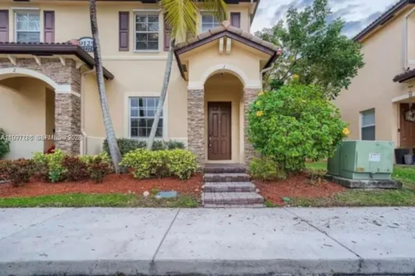a front view of a house with garden