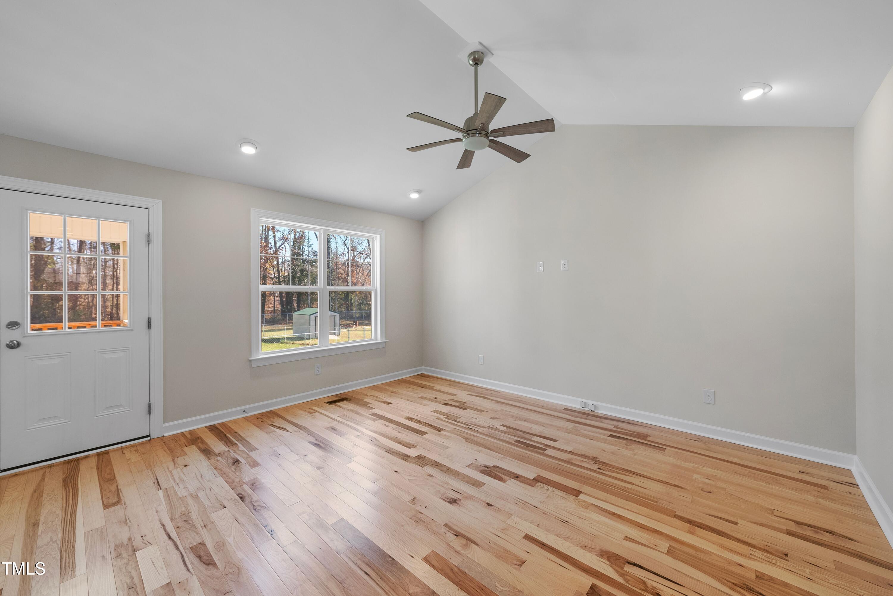 9425 Meredith Drive Rougemont, NC 27572 - Photo 12 of 29 a view of an empty room with a window and wooden floor