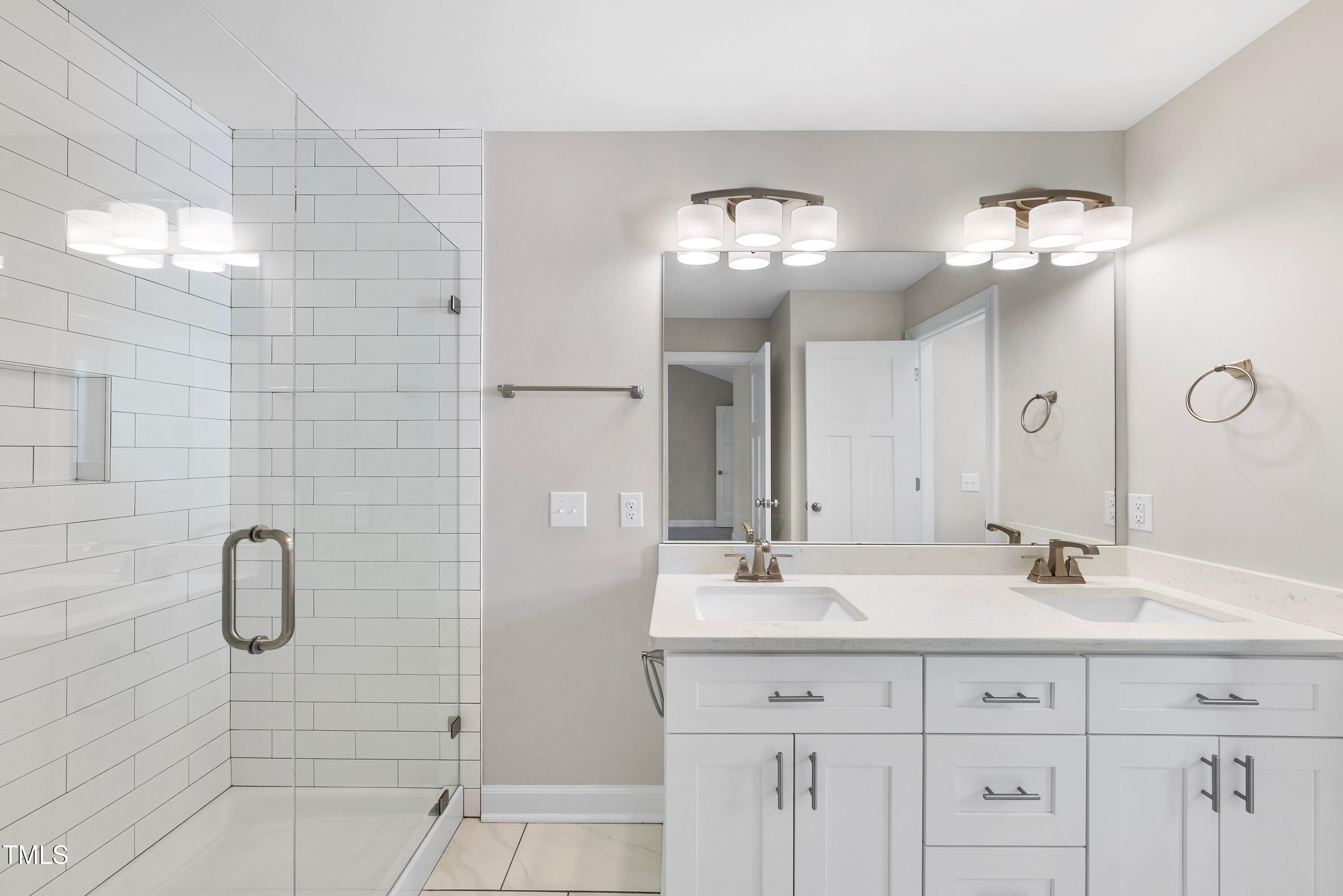 9425 Meredith Drive Rougemont, NC 27572 - Photo 13 of 29 a bathroom with a double sink shower and a mirror