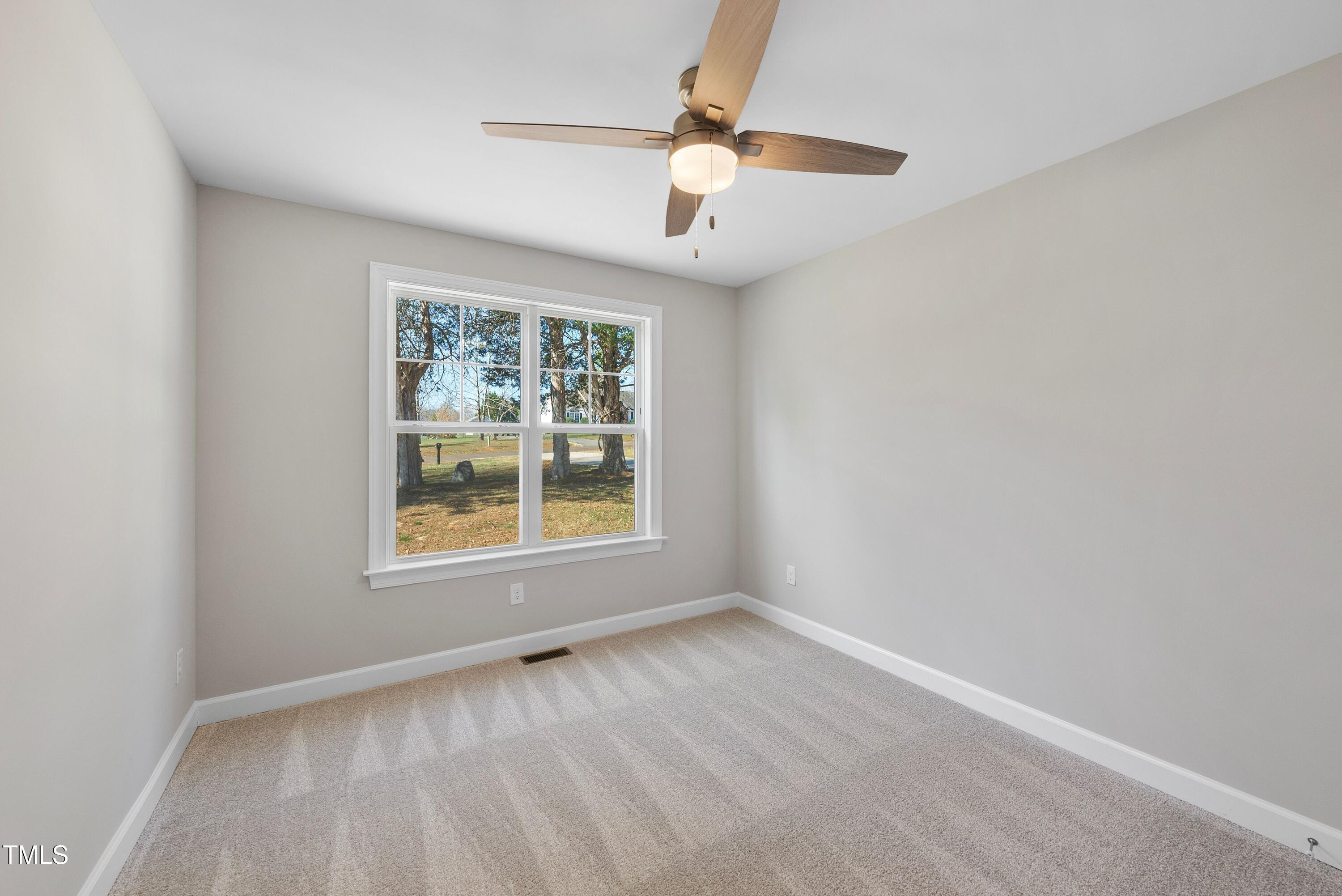 9425 Meredith Drive Rougemont, NC 27572 - Photo 18 of 29 an empty room with a window and a fan