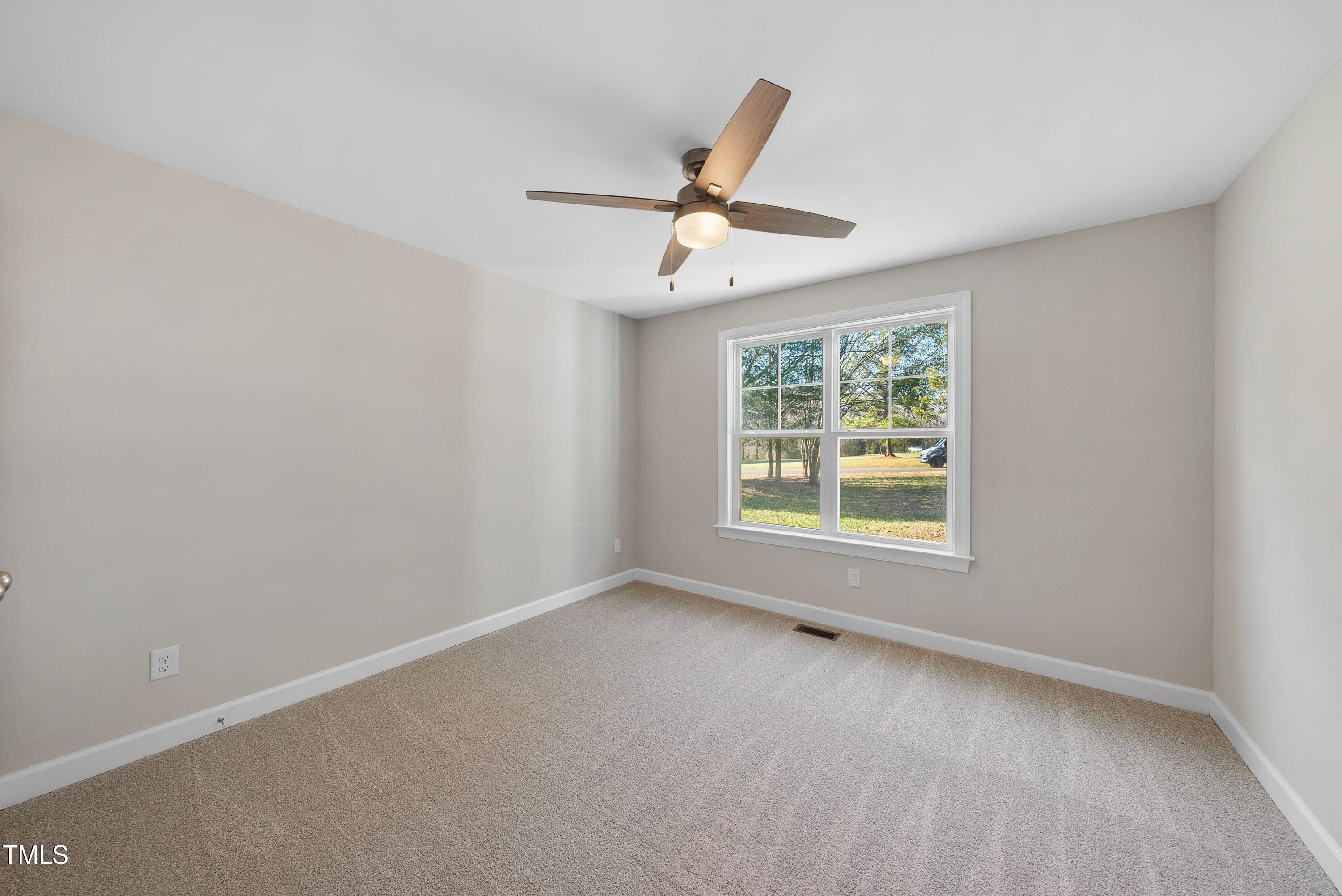 9425 Meredith Drive Rougemont, NC 27572 - Photo 19 of 29 a view of a room with windows and ceiling fan