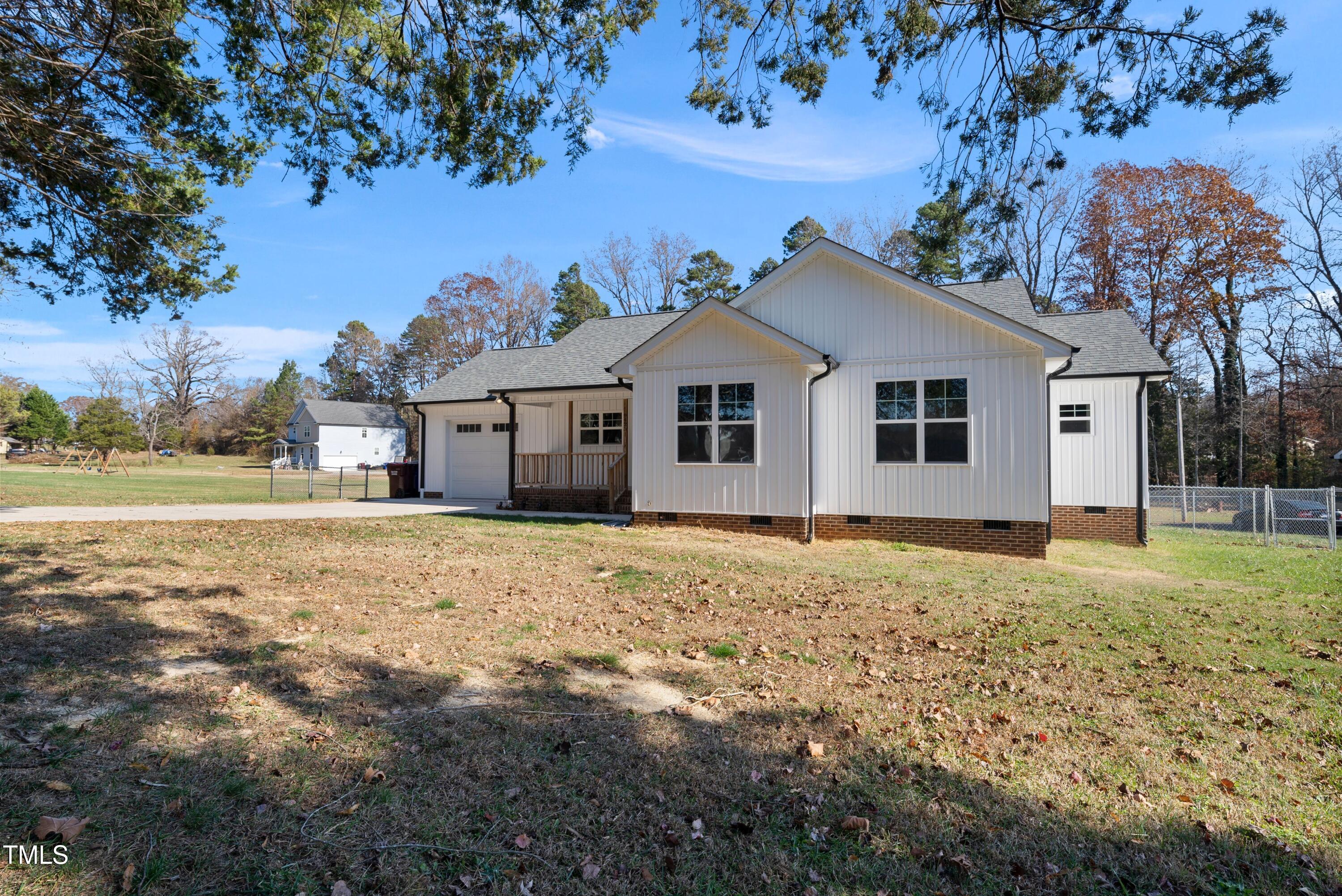 9425 Meredith Drive Rougemont, NC 27572 - Photo 2 of 29 a house with trees in the background