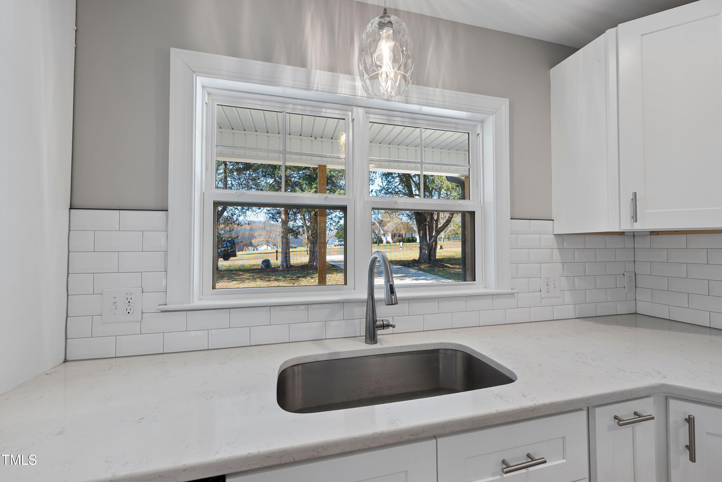 9425 Meredith Drive Rougemont, NC 27572 - Photo 3 of 29 a kitchen with granite countertop a sink and a window