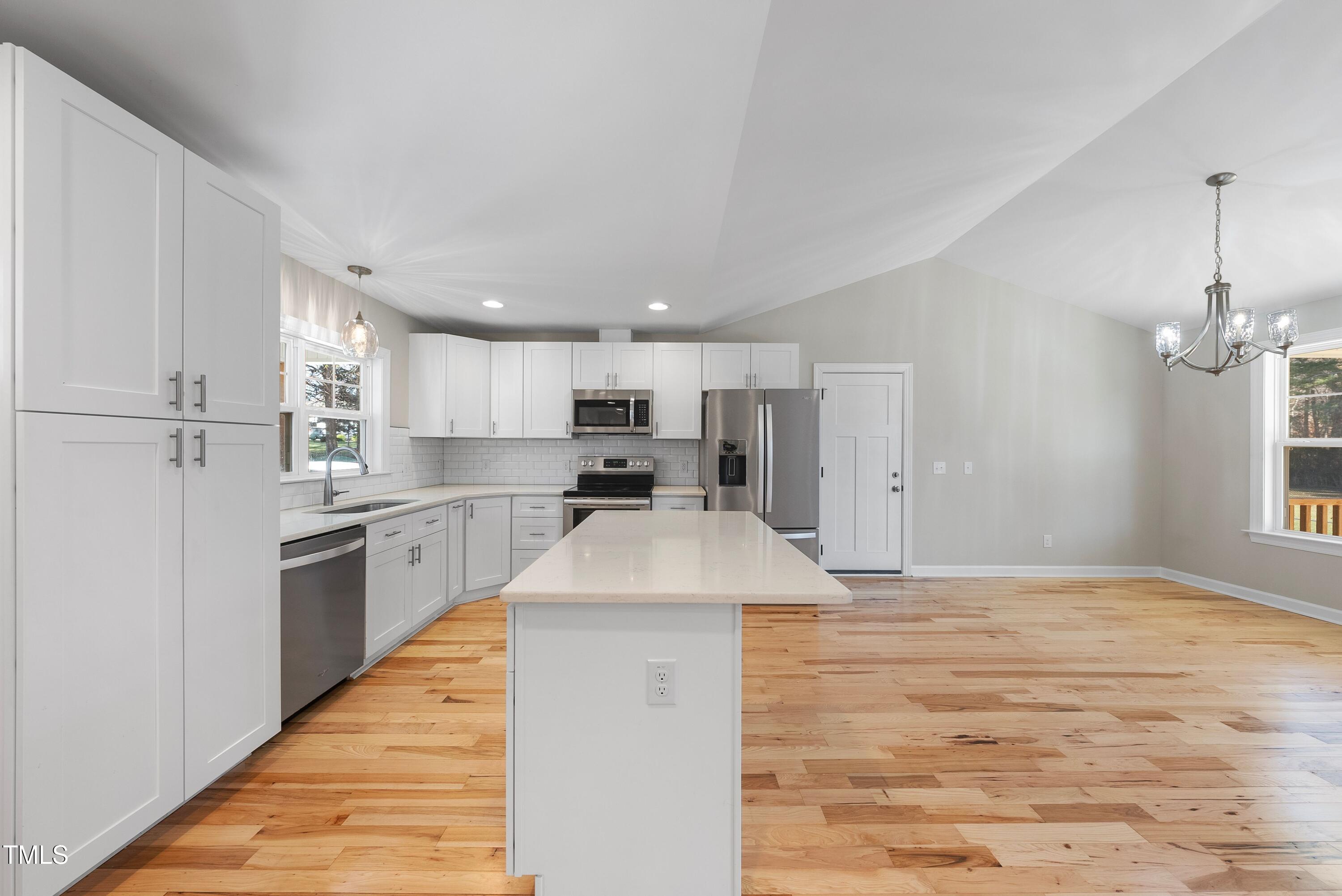 9425 Meredith Drive Rougemont, NC 27572 - Photo 5 of 29 a large kitchen with kitchen island a sink stainless steel appliances and cabinets