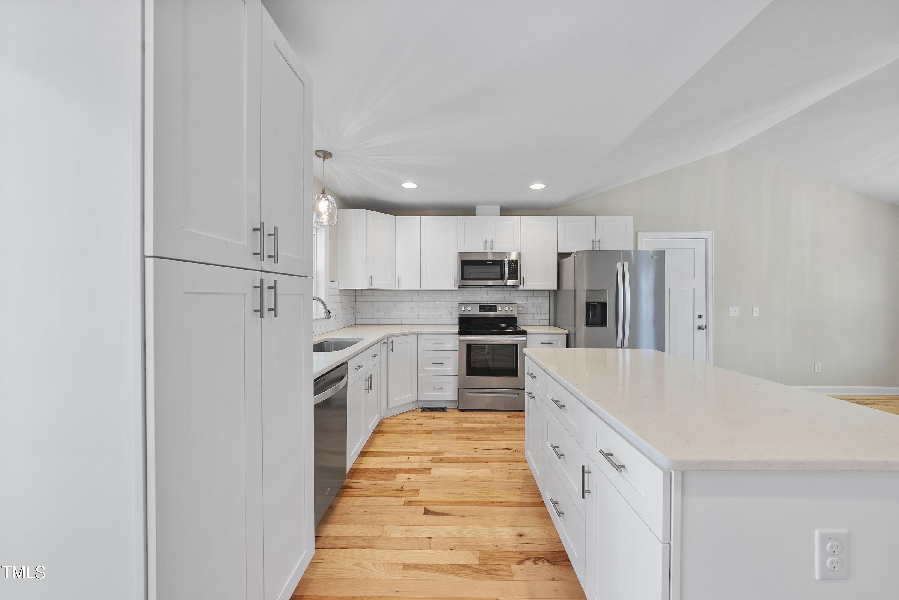 9425 Meredith Drive Rougemont, NC 27572 - Photo 6 of 29 a large kitchen with white cabinets and white stainless steel appliances