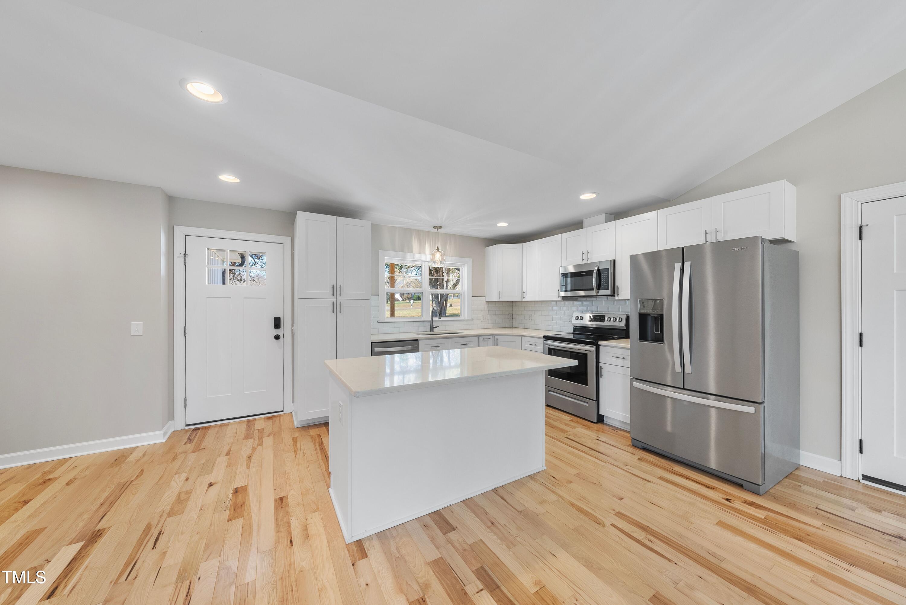 9425 Meredith Drive Rougemont, NC 27572 - Photo 7 of 29 a kitchen with wooden floors and stainless steel appliances