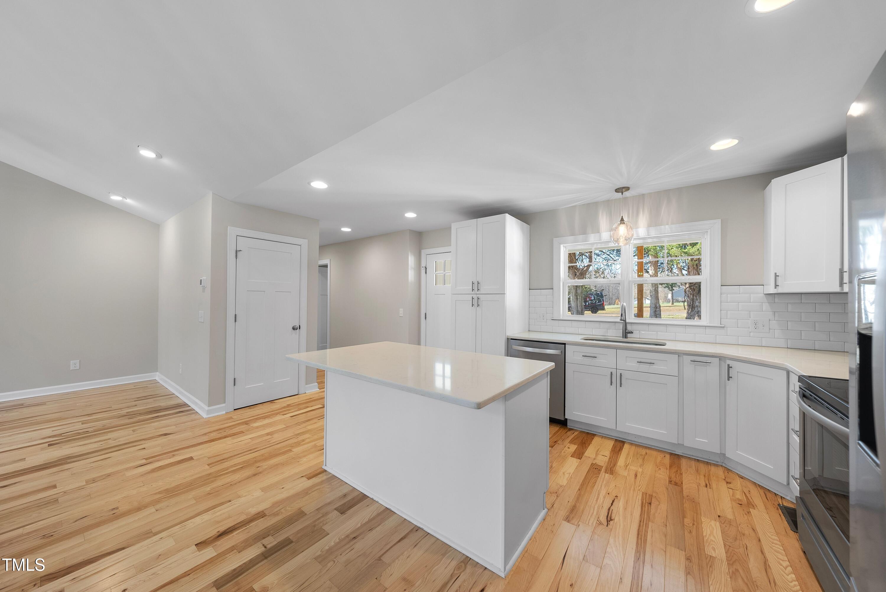 9425 Meredith Drive Rougemont, NC 27572 - Photo 8 of 29 a large kitchen with wooden floor and stainless steel appliances