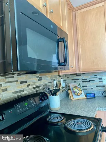 a kitchen with a sink a counter top space and cabinets