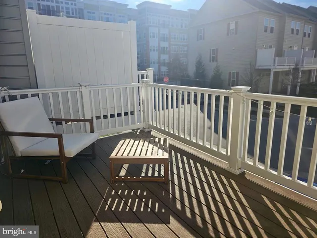 a view of a roof deck with wooden floor and fence
