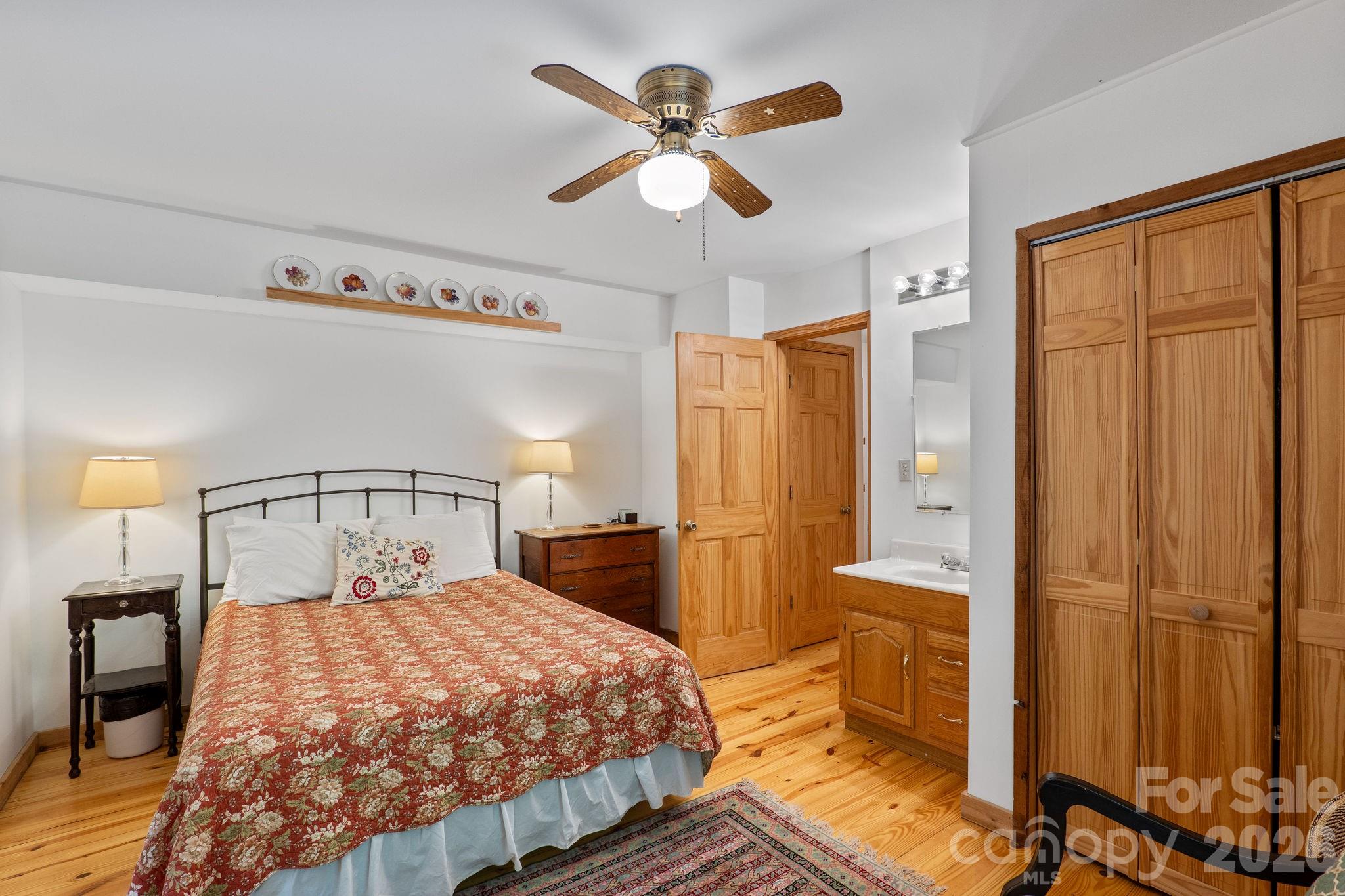 150 Avondale Ridge Road Asheville, NC 28803 - Photo 22 of 45 a bedroom with a large bed and a chandelier