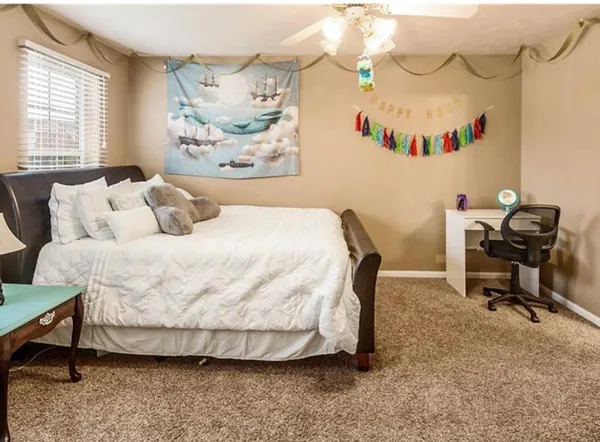 a bedroom with a bed and a table in it