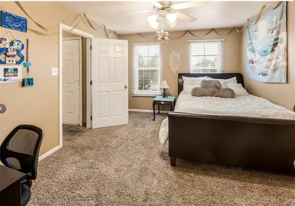 a bedroom with a bed and window