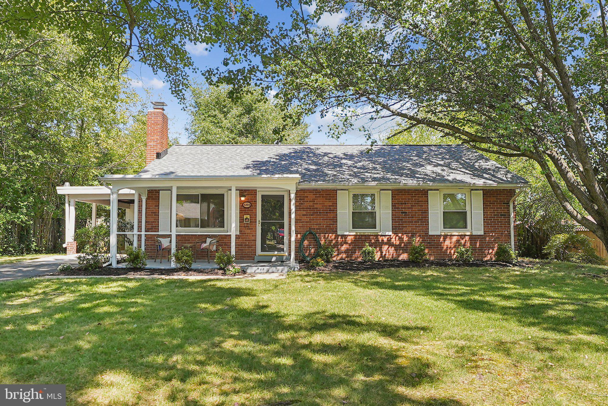 a front view of house with yard outdoor seating and green space