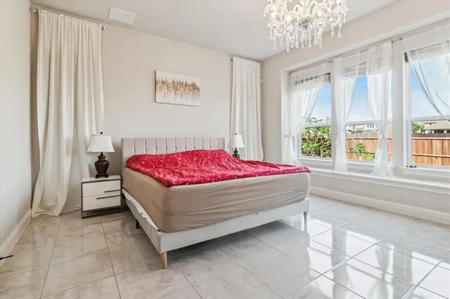 a bedroom with a bed and a large window