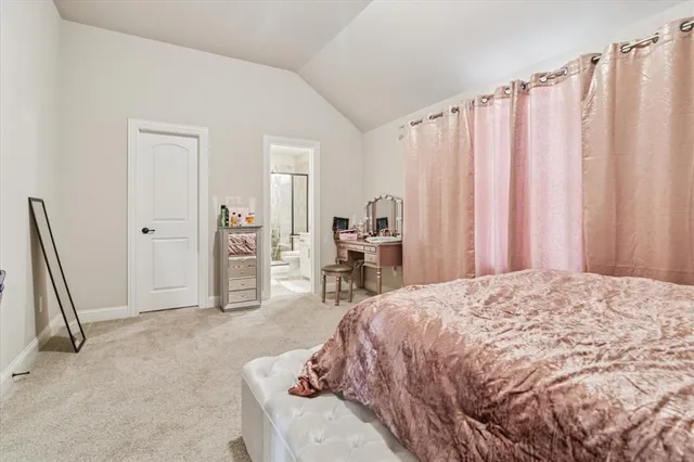 a spacious bedroom with a bed and a chair