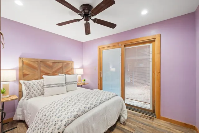 a bedroom with a bed and a glass door