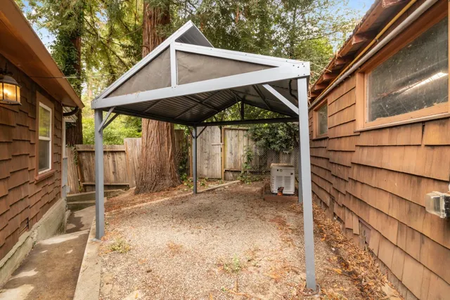 a backyard of a house with barbeque oven table and chairs