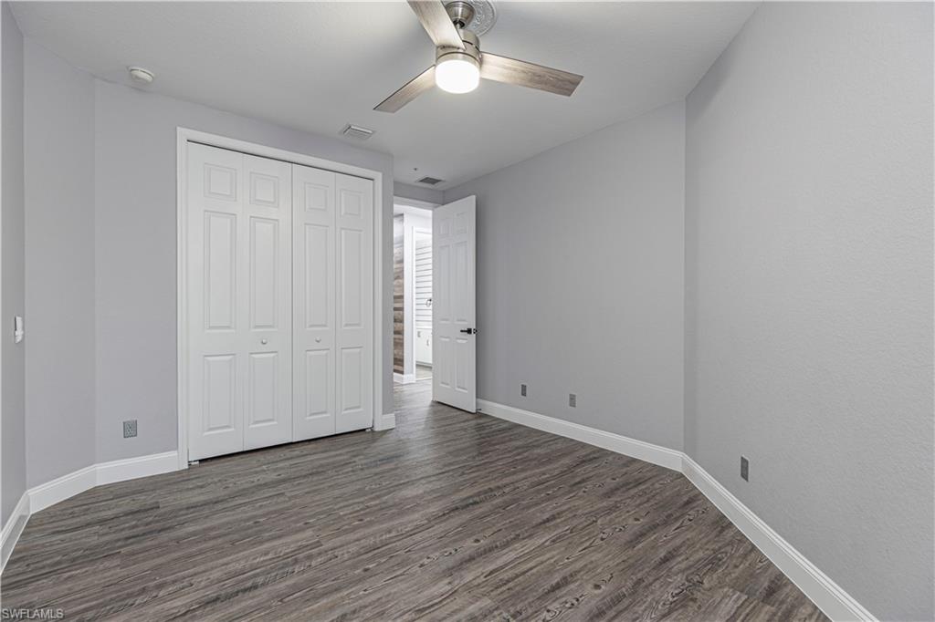 1330 Mariposa Circle, Unit 103 Naples, FL 34105 - Photo 21 of 32 a view of an empty room with wooden floor
