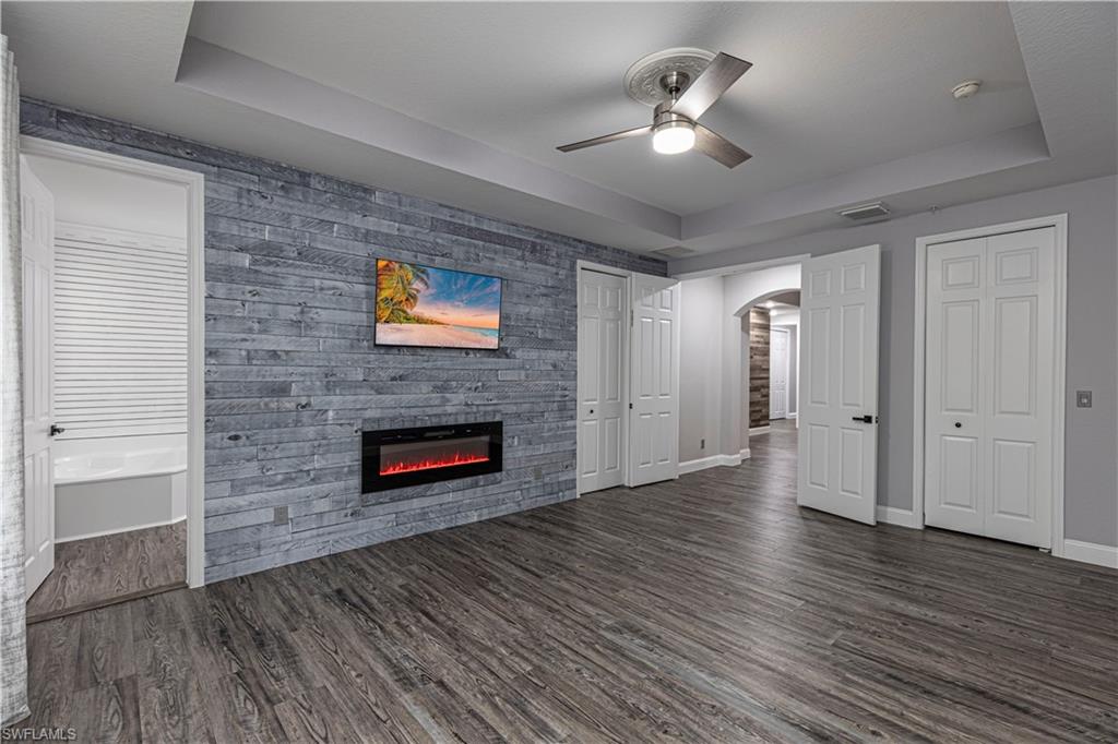 1330 Mariposa Circle, Unit 103 Naples, FL 34105 - Photo 23 of 32 wooden floor in an empty room with a window
