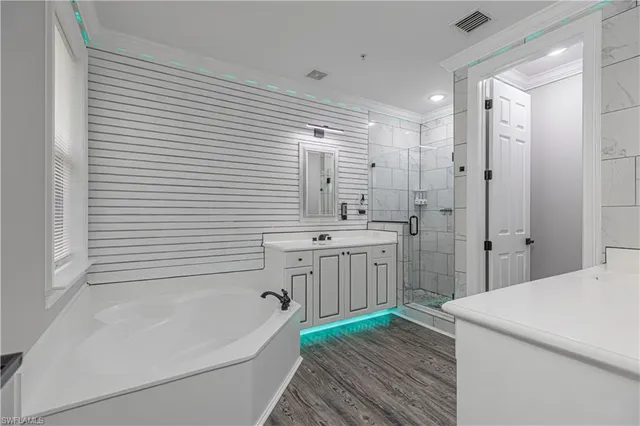 a spacious bathroom with a double vanity sink a mirror and a shower