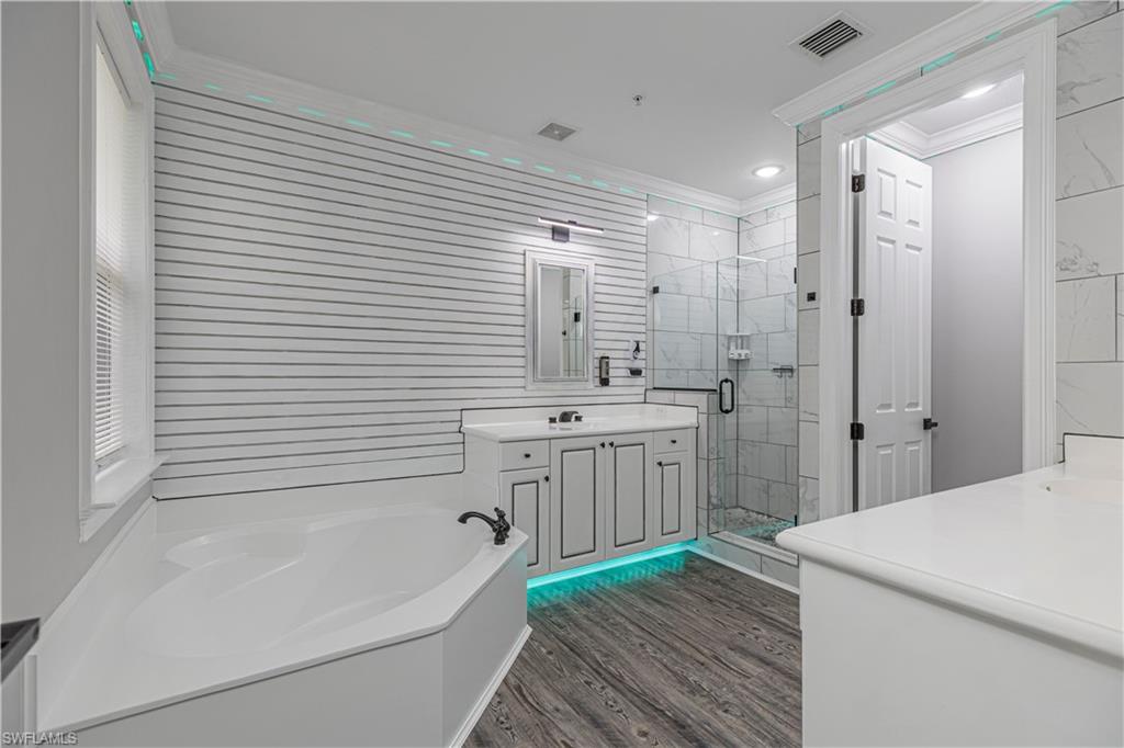 1330 Mariposa Circle, Unit 103 Naples, FL 34105 - Photo 24 of 32 a bathroom with a sink a bathtub and a shower