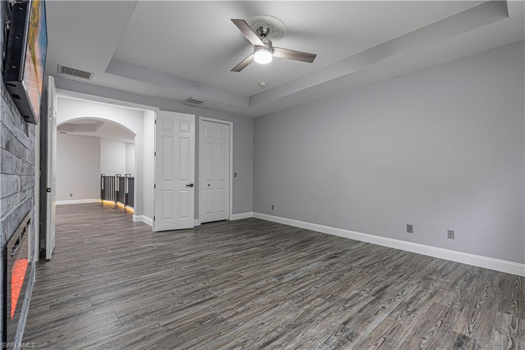 1330 Mariposa Circle, Unit 103 Naples, FL 34105 - Photo 26 of 32 wooden floor in an empty room with a window