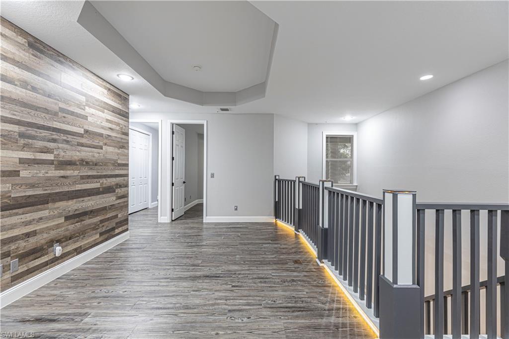 1330 Mariposa Circle, Unit 103 Naples, FL 34105 - Photo 27 of 32 a view of a hallway with wooden floor