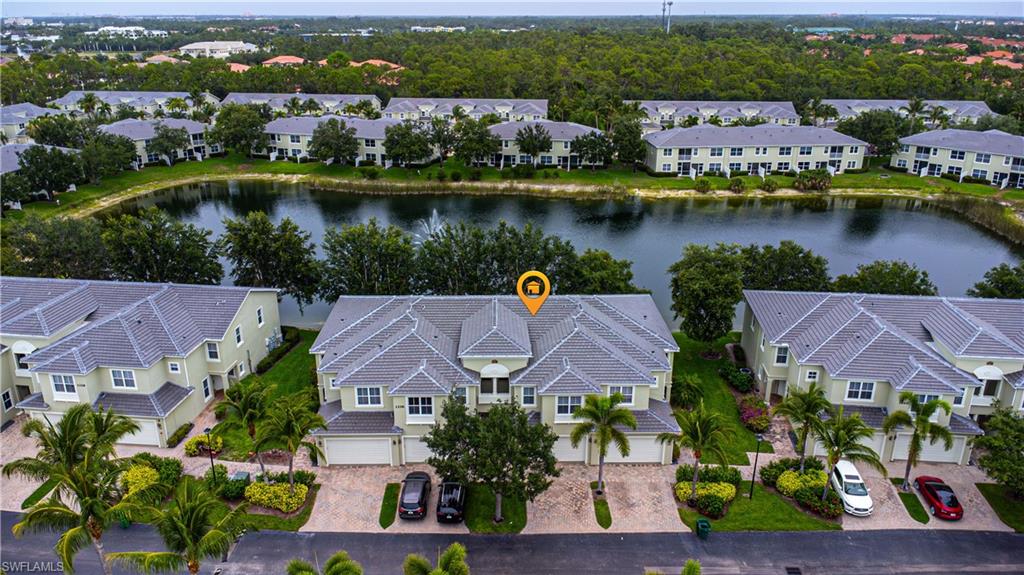 1330 Mariposa Circle, Unit 103 Naples, FL 34105 - Photo 28 of 32 an aerial view of a house with a lake view