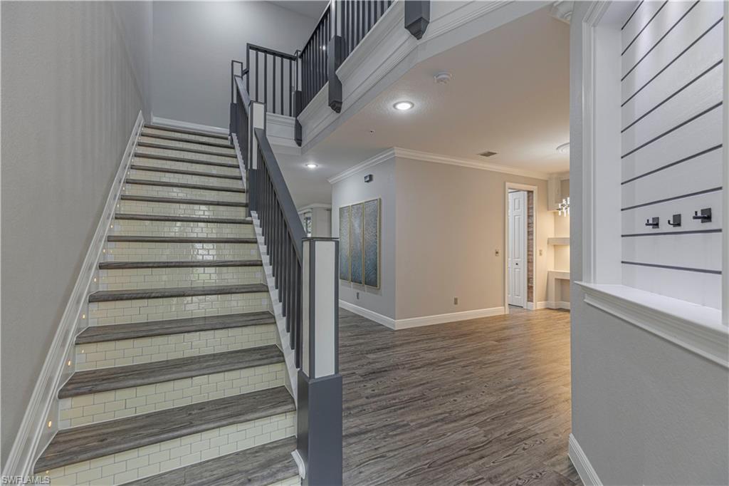 1330 Mariposa Circle, Unit 103 Naples, FL 34105 - Photo 6 of 32 a view of an entryway with wooden floor